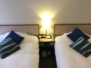 Postel nebo postele na pokoji v ubytování Hakuba Yamano Hotel
