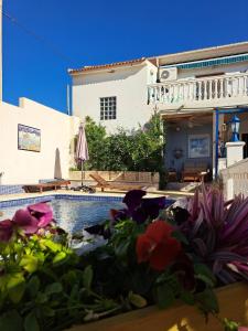 dom z basenem i kwiatami na pierwszym planie w obiekcie Casa de los Suenos Granada 