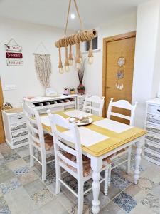 a dining room with a white table and chairs at Casa de los Suenos Granada 