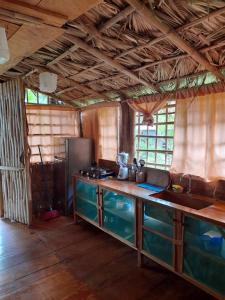 a kitchen with a sink and a counter in a room at El Bamboo Cabins in Balgue