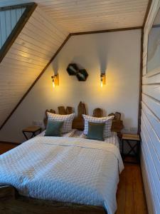 a bedroom with a large bed in a attic at Girskiy Svitanok in Slavske