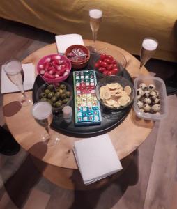 - une table avec une assiette de nourriture et des verres à vin dans l'établissement chez Mirka 2 chambres, à Criel-sur-Mer