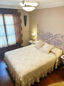 a bedroom with a large bed in a room at La Llosa de Sámano in Castro-Urdiales