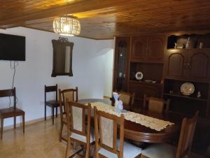 a dining room with a table and some chairs at Casa Fuentefria in Ourense