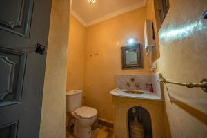 a small bathroom with a toilet and a sink at Riad Azawan in Marrakech