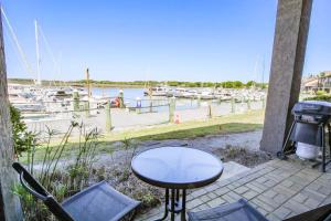a table and chairs on a patio near a marina at Bohicket Marina Condo in Seabrook Island