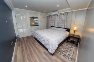 a bedroom with a bed and a table and a window at JR Apartments in Georgetown