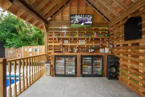 a wooden cabin with a tv on the wall at Incredible summer winter 32c heated pool hot tub bar in Kent