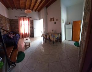a kitchen and dining room with a table and a refrigerator at Agapis Apartments in Petra