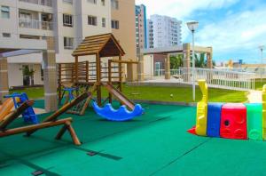 a playground with a slide and a swing set at Aptos atrás da Passarela do Caranguejo in Aracaju