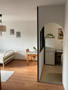 a living room with a refrigerator and a table at Apartament Dobre Miejsce in Malbork