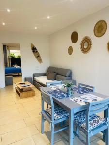 a living room with a table and chairs and a couch at Magnifique T2 en bord de mer in Le Lavandou