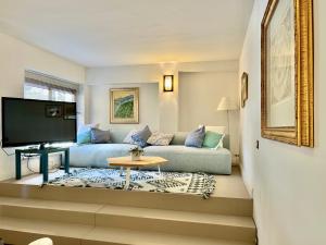 a living room with a couch and a tv at Taormina Casa Liliana in Taormina