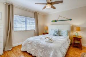 a bedroom with a white bed with a teddy bear on it at Beach 2 level spacious condo in Fort Lauderdale
