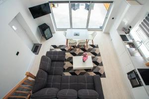 an overhead view of a living room with a couch and a table at Incredible summer winter 32c heated pool hot tub bar in Kent