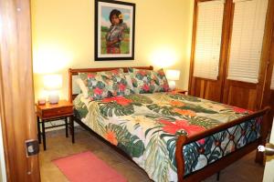 a bedroom with a bed with a floral comforter at Secluded Ocean Front Overlooking the Marina in San Carlos