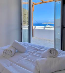 a white bed with towels on it in front of a window at Juli’s Suites in Mérikhas