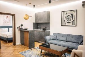 a living room with a couch and a kitchen at Giardino Lux Apartments in Ulcinj