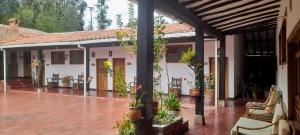 a patio of a house with flowers and plants at Hotel MAXIRUMA - Villa TAMAUKA in Iza