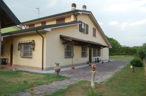 a large yellow house with a vase in front of it at 4 giugno Ferrara in Ferrara