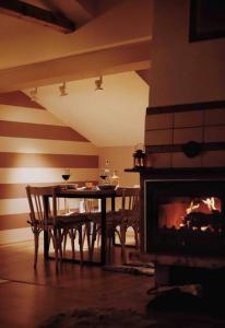 a dining room with a table and a fireplace at Mansard underneath the stars 