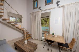 a living room with a table and a staircase at Kampos Apartment in Vasiliki