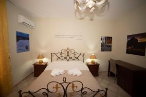 a bedroom with a bed with two pillows on it at B&B La Terrazza Degli Scrittori in Racalmuto