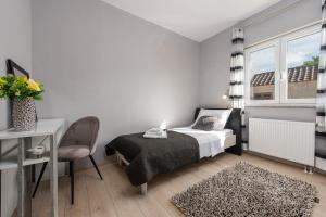 a bedroom with a bed and a chair and a window at Holiday house Karla in Zadar +23 photos