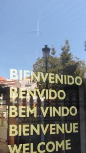 
a sign on a pole in front of a building at Loop INN Hotel Santiago de Compostela in Santiago de Compostela
