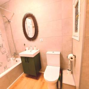 a bathroom with a toilet and a sink and a mirror at MarSolRosas in Hospitalet de l'Infant