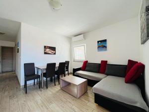 a living room with a couch and a table at Apartman Bobovik in Vir