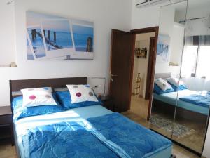 a bedroom with two beds and a mirror at Apartment Haifa in Haifa