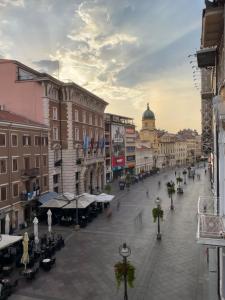 a view of a street in a city with buildings at Linden Korzo with balcony in Rijeka