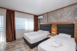 Postel nebo postele na pokoji v ubytování Sunday Beach Hotel