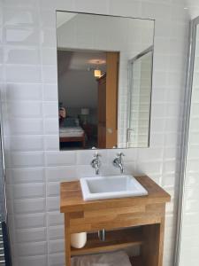 a bathroom with a sink and a mirror at Corsee House in Nairn