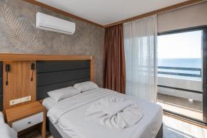 Postel nebo postele na pokoji v ubytování Sunday Beach Hotel
