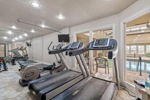 a gym with two treadmills and a treadmill at Croatan Surf Club by KEES Vacations in Kill Devil Hills