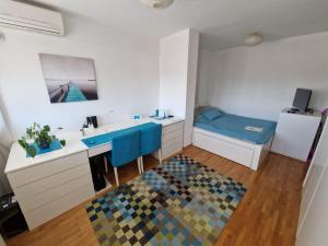 a small bathroom with a sink and a desk at Harmony Apartment in Belgrade