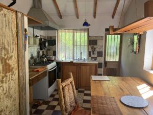 a kitchen with a wooden table and a counter top at Alcohuaz Indomito in Alcoguaz