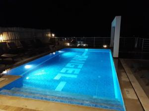a large blue swimming pool at night at Villa Alya, spacious 4 bed villa with private pool in Fethiye