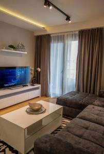 a living room with a couch and a table at Apartment Leona in Kraljevo