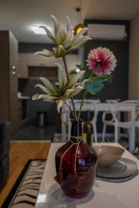 a vase with flowers in it sitting on a table at Apartment Leona in Kraljevo