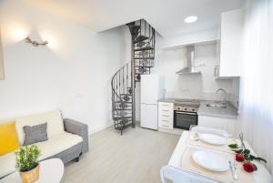 a kitchen and living room with a couch and a table at Soul Home Alhaurín el Grande in Alhaurín el Grande