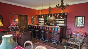 a woman standing at a bar in a restaurant at Cambus O' May Traditional Highland Hotel in Ballater