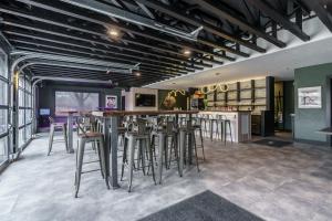 a bar with stools in a room with a counter at The Scout INN in Cody