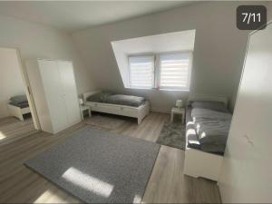 a bedroom with two beds and a window and a rug at 2 Zimmer,Apartment,Monteur,Netflix,Prima in Krefeld