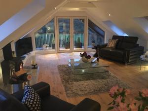 a living room with a couch and a table at Invercreran Lodge Luxury Bed & Breakfast in Appin