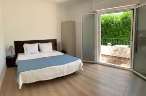 una camera con un grande letto e un balcone di Ciao Tavira a Tavira