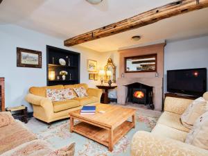 a living room with two couches and a fireplace at The Farmhouse in Bakewell