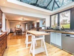 an open kitchen with a large glass ceiling at The Farmhouse in Bakewell